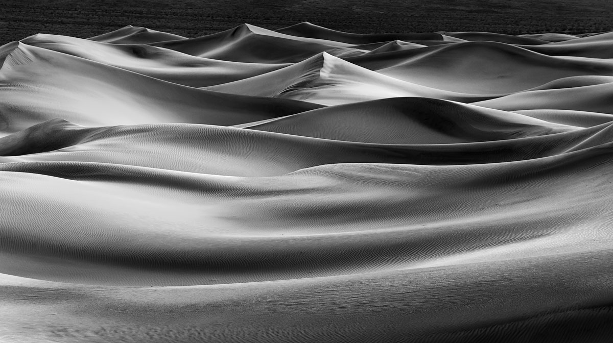 Silky soft sand dunes glow after the sun dips below the horizon.